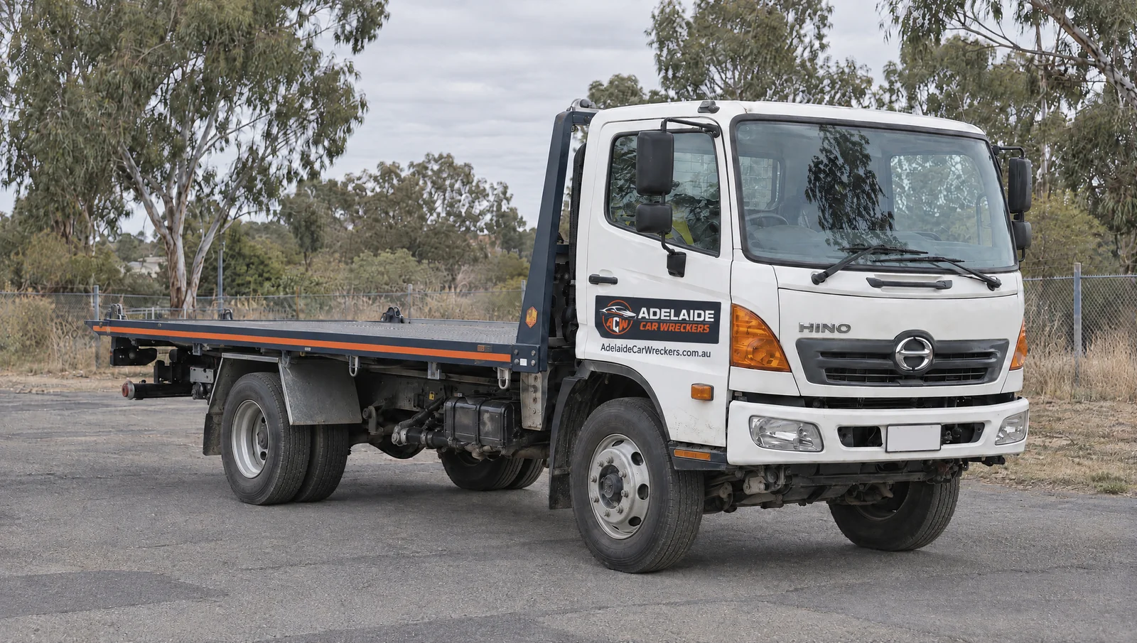 Illustration of a flatbed truck with Adelaide Car Wreckers branding.